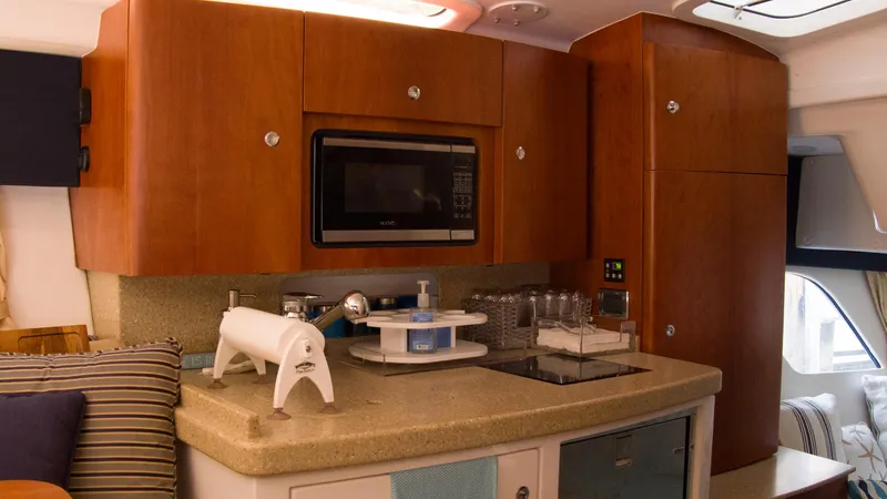 R&r Yacht Photos Pics 2017 Intrepid 400 Cuddy interior kitchen with microwave and wooden cabinets.