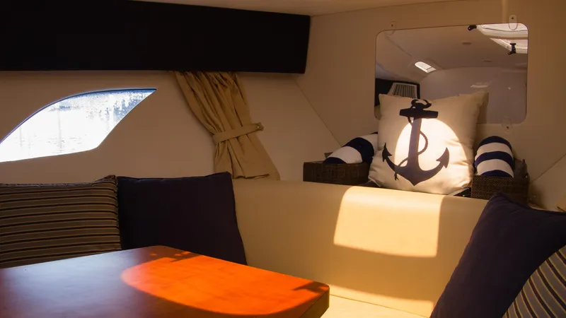 R&r Yacht Photos Pics Interior of 2017 Intrepid 400 Cuddy with nautical-themed decor and window view.