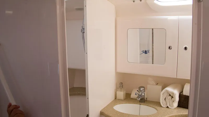 R&r Yacht Photos Pics 2017 Intrepid 400 Cuddy bathroom with sink, mirror, and storage.