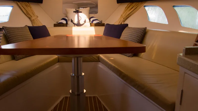 R&r Yacht Photos Pics Interior of 2017 Intrepid 400 Cuddy with cozy seating and nautical decor.