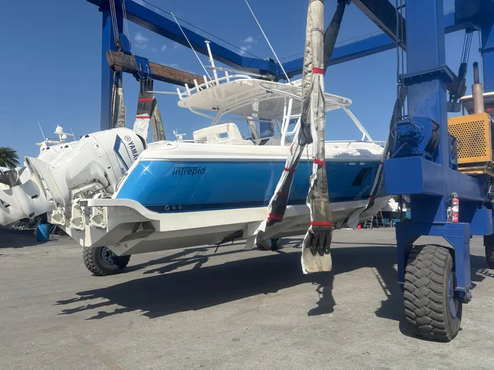 R&r Yacht Photos Pics 2017 Intrepid 400 Cuddy boat lifted by crane, featuring Yamaha engines.