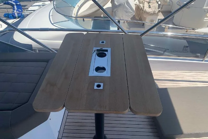 Pardo Endurance 60 Yacht Photos Pics Luxury deck table on 2023 Pardo Yachts E60, featuring sleek wood design.