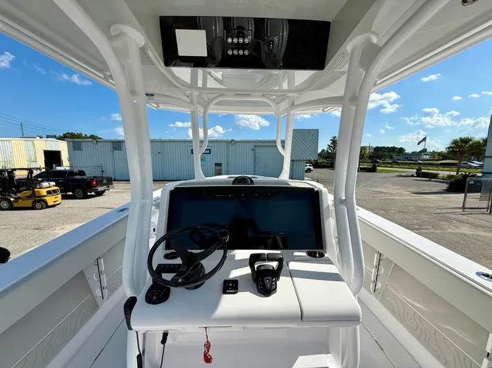  Yacht Photos Pics 2026 Jupiter 34 boat console with steering wheel and controls, parked outdoors under clear sky.