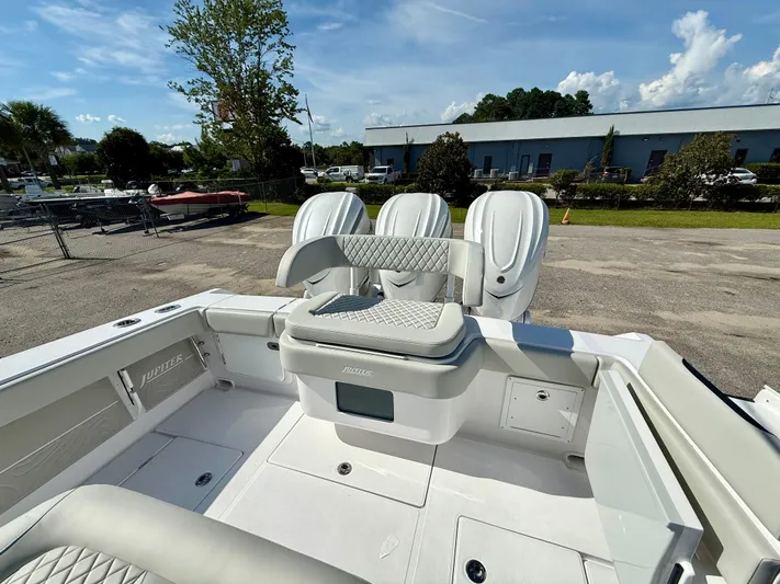  Yacht Photos Pics 2026 Jupiter 34 boat with triple engines, luxurious seating, and sleek design in a marina setting.