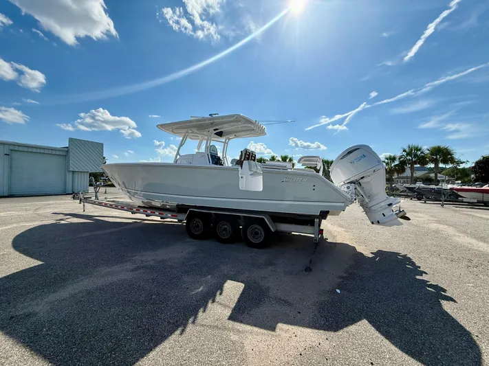  Yacht Photos Pics 2026 Jupiter 34 boat on trailer under clear blue sky.