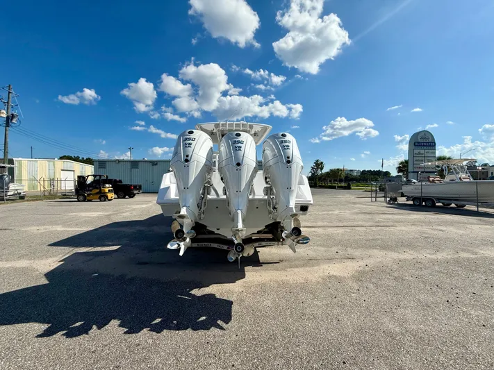  Yacht Photos Pics 2026 Jupiter 34 boat with triple 350 V8 engines, parked under a clear blue sky.