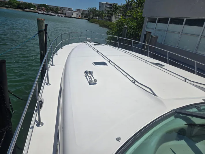 Michael B Yacht Photos Pics 1998 Sea Ray 500 Sundancer yacht docked by the water, showcasing sleek deck design.