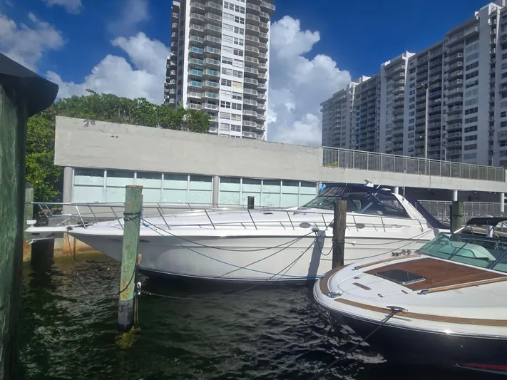 Michael B Yacht Photos Pics 1998 Sea Ray 500 Sundancer yacht docked near high-rise buildings under a blue sky.