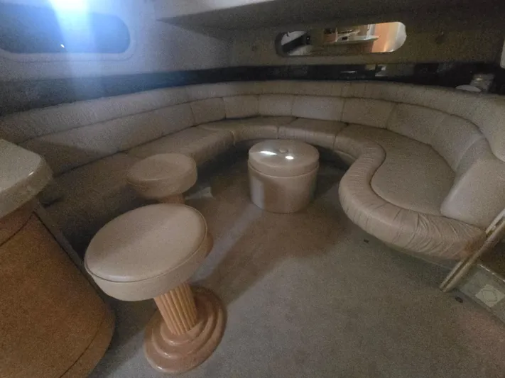 Michael B Yacht Photos Pics Interior of 1998 Sea Ray 500 Sundancer yacht with beige leather seating and stools.