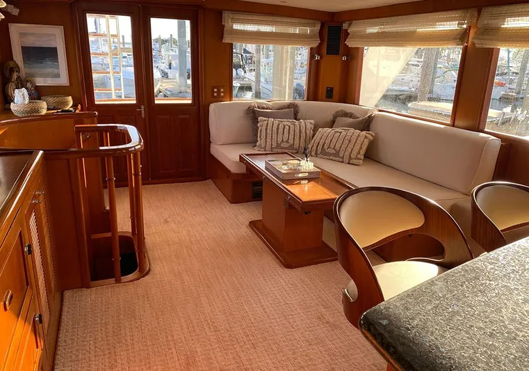 Bochinche Yacht Photos Pics Luxurious interior of 2006 Grand Alaskan 65 Flush Deck yacht with elegant seating and wooden finishes.