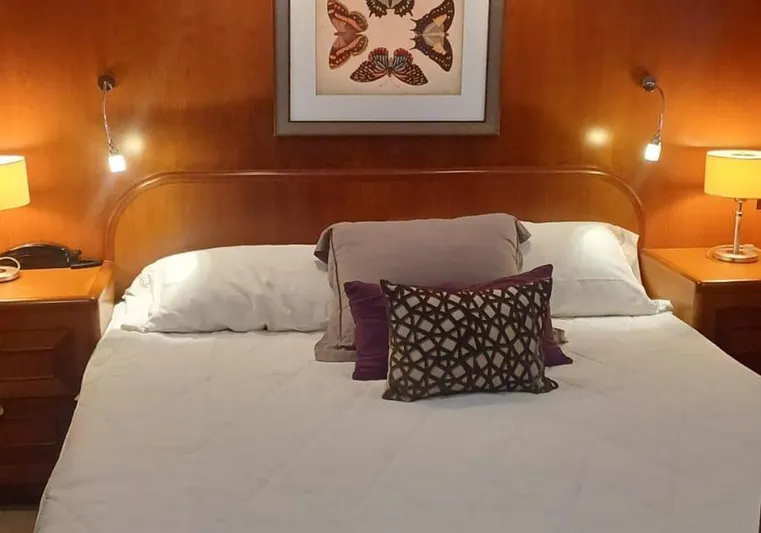 Bochinche Yacht Photos Pics Luxurious bedroom interior of 2006 Grand Alaskan 65 Flush Deck yacht with elegant decor.