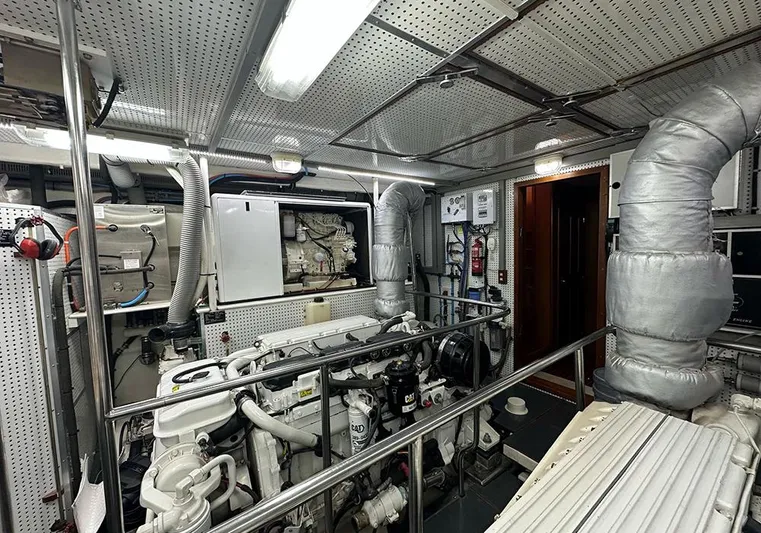 Bochinche Yacht Photos Pics Engine room of 2006 Grand Alaskan 65 Flush Deck yacht, featuring mechanical equipment and piping.