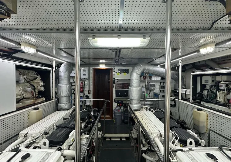 Bochinche Yacht Photos Pics Engine room of 2006 Grand Alaskan 65 Flush Deck yacht, featuring dual engines and control systems.