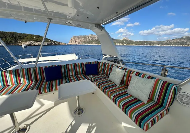 Bochinche Yacht Photos Pics Colorful seating on 2006 Grand Alaskan 65 Flush Deck yacht with scenic ocean view.