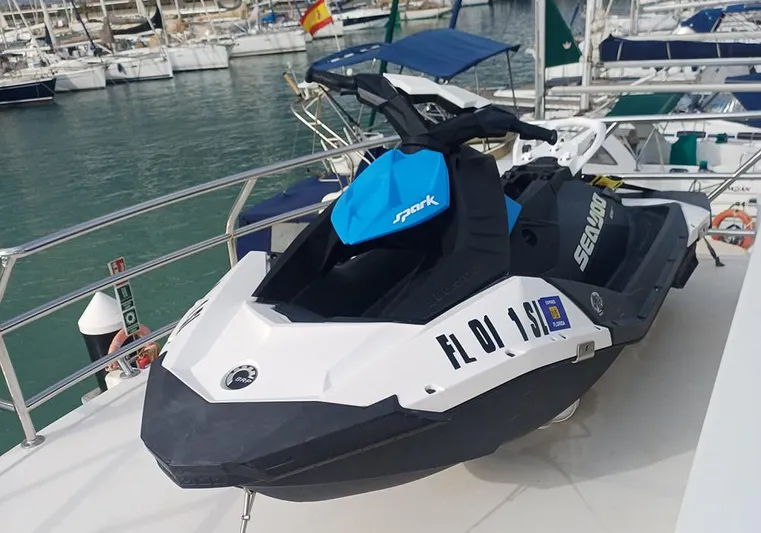 Bochinche Yacht Photos Pics Jet ski on a 2006 Grand Alaskan 65 Flush Deck yacht in a marina.