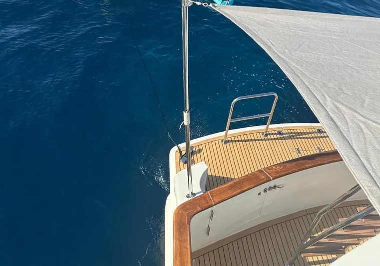 Bochinche Yacht Photos Pics Deck view of 2006 Grand Alaskan 65 Flush Deck yacht on blue ocean water.