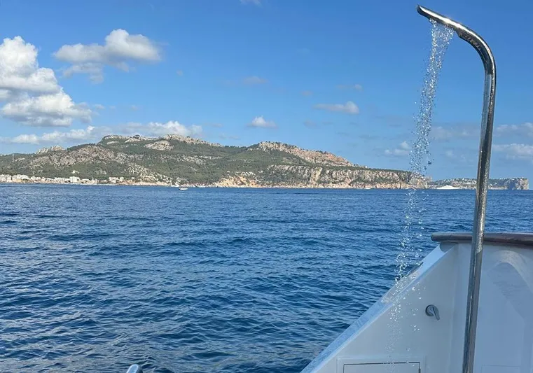 Bochinche Yacht Photos Pics Outdoor shower on 2006 Grand Alaskan 65 Flush Deck yacht with scenic ocean view.