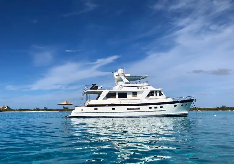 Bochinche Yacht Photos Pics 2006 Grand Alaskan 65 Flush Deck yacht on clear blue water under a bright sky.