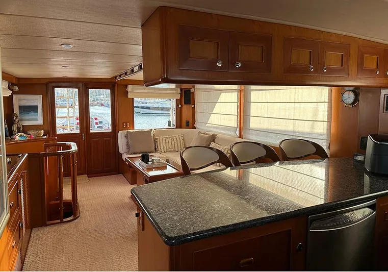 Bochinche Yacht Photos Pics Luxurious interior of 2006 Grand Alaskan 65 Flush Deck yacht with elegant wood finishes.