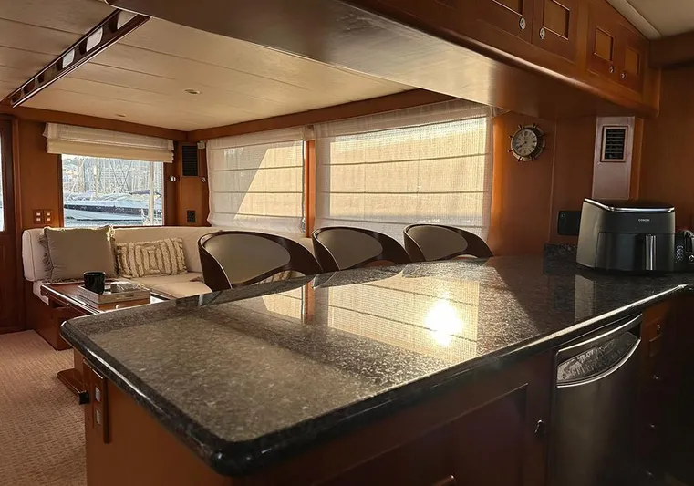 Bochinche Yacht Photos Pics Luxurious interior of 2006 Grand Alaskan 65 Flush Deck yacht with elegant seating and modern amenities.