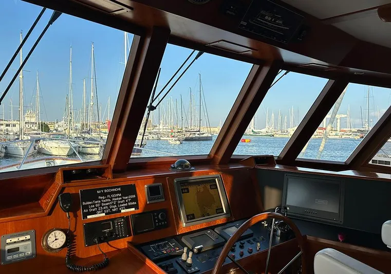 Bochinche Yacht Photos Pics Interior view of 2006 Grand Alaskan 65 Flush Deck yacht cockpit with marina in background.