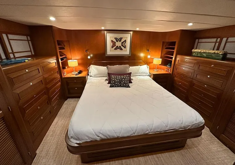 Bochinche Yacht Photos Pics Luxurious bedroom in 2006 Grand Alaskan 65 Flush Deck yacht with elegant wood cabinetry.