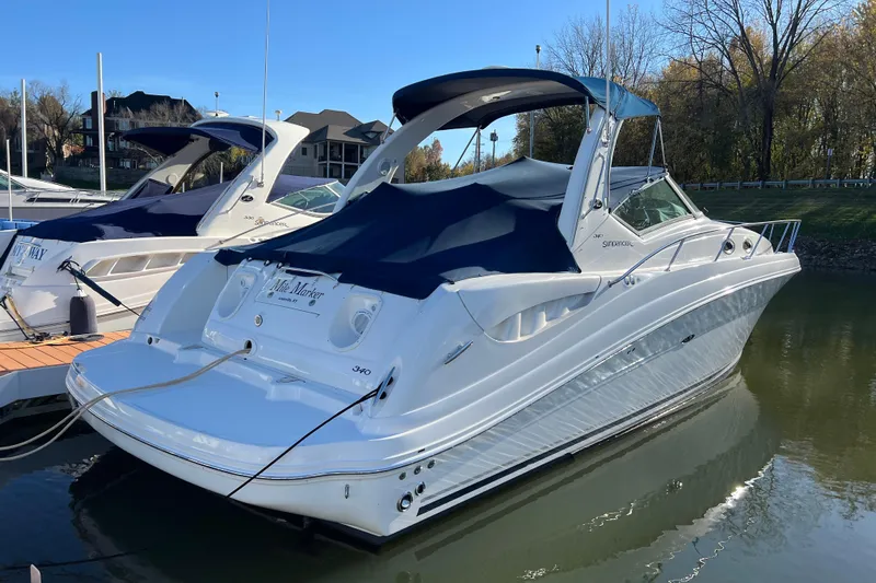 Mile Marker Yacht Photos Pics 2008 Sea Ray 340 Sundancer docked, featuring sleek design and blue canopy.