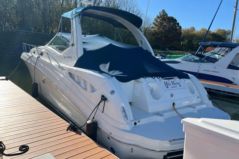 Mile Marker Yacht Photos Pics 2008 Sea Ray 340 Sundancer docked, covered with a blue canopy, in a serene marina setting.