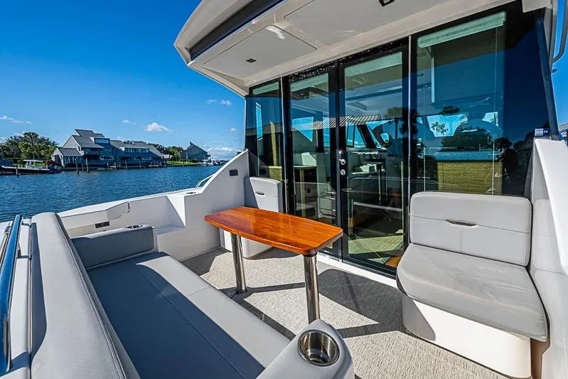 Polaris Yacht Photos Pics 2018 Tiara Yachts C39 Coupe with outdoor seating and scenic waterfront view.