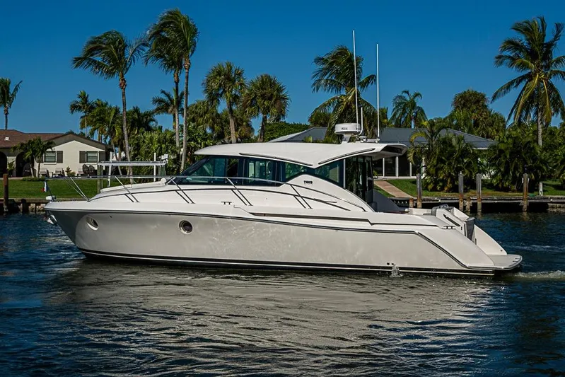 Polaris Yacht Photos Pics 2018 Tiara Yachts C39 Coupe cruising on a sunny day with palm trees in background.