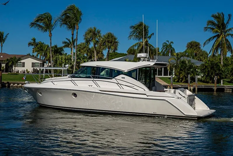 Polaris Yacht Photos Pics 2018 Tiara Yachts C39 Coupe cruising on a sunny day with palm trees in the background.