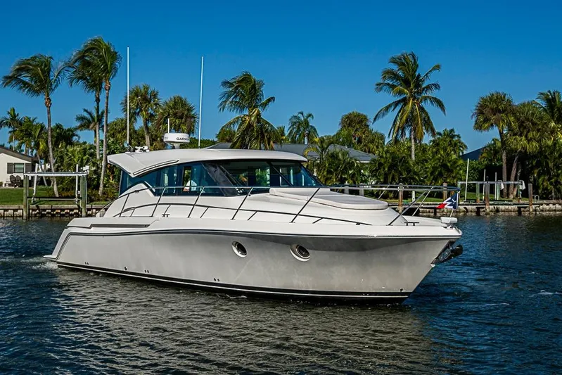 Polaris Yacht Photos Pics 2018 Tiara Yachts C39 Coupe cruising on a sunny day with palm trees in the background.