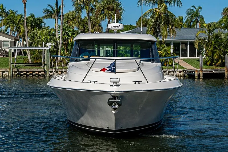 Polaris Yacht Photos Pics 2018 Tiara Yachts C39 Coupe on water, surrounded by palm trees and waterfront homes.