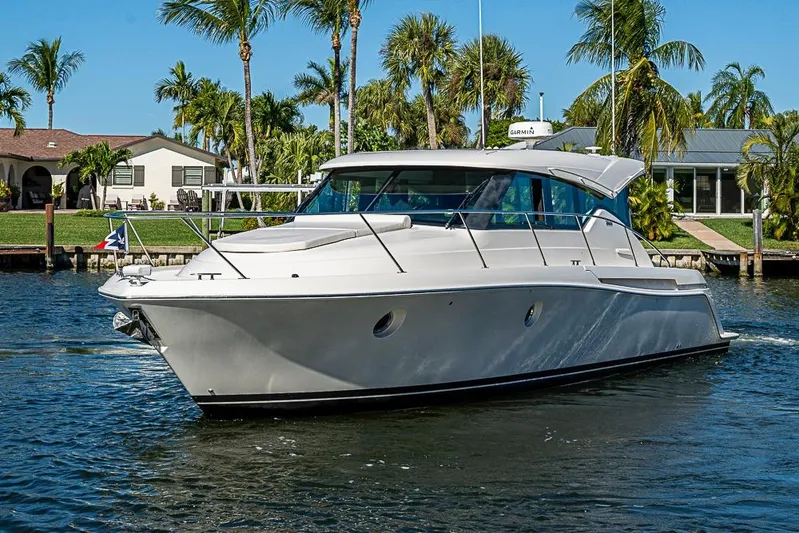 Polaris Yacht Photos Pics 2018 Tiara Yachts C39 Coupe cruising on a sunny day near palm trees.