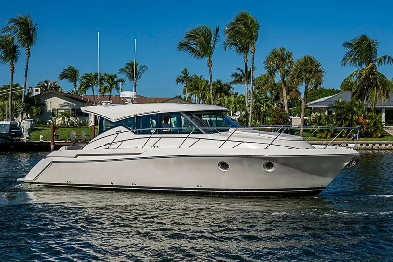 Polaris Yacht Photos Pics 2018 Tiara Yachts C39 Coupe cruising on a sunny day with palm trees in the background.