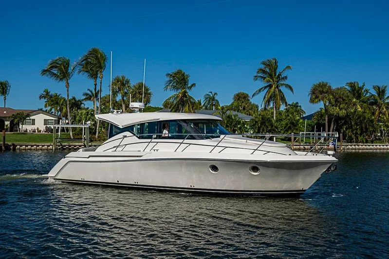 Polaris Yacht Photos Pics 2018 Tiara Yachts C39 Coupe cruising on a sunny day with palm trees in the background.