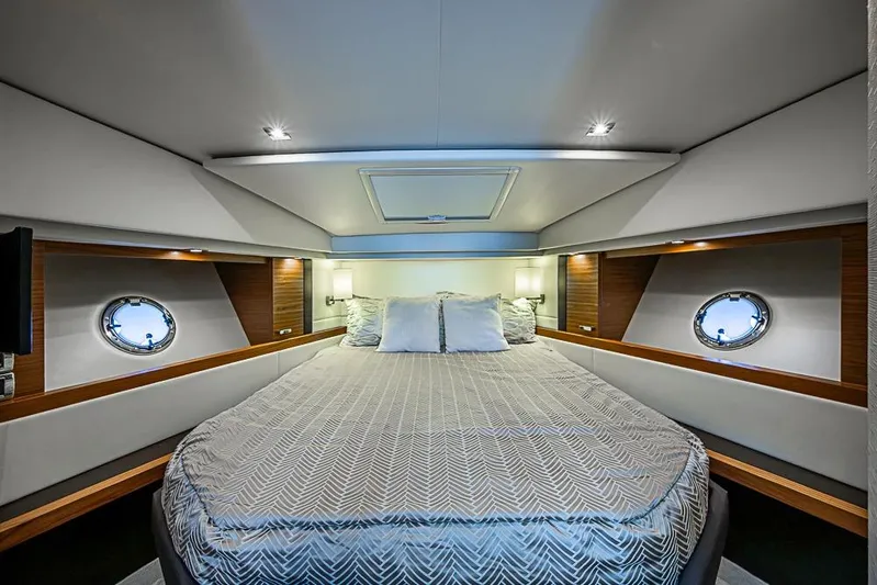 Polaris Yacht Photos Pics Luxurious 2018 Tiara Yachts C39 Coupe cabin interior with elegant bedding and porthole windows.