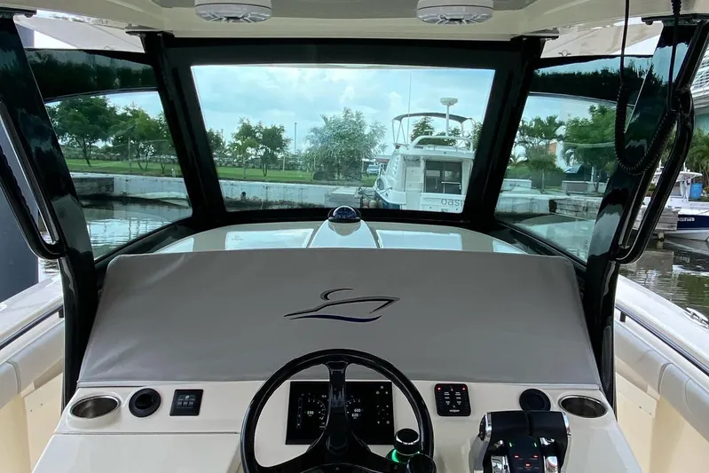  Yacht Photos Pics Interior view of 2020 Scout 355 LXF boat cockpit with steering wheel and controls.