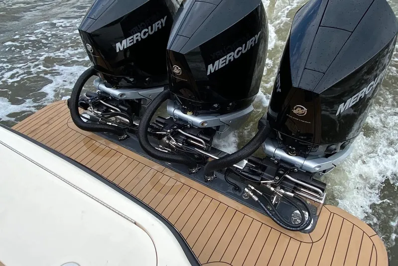  Yacht Photos Pics Triple Mercury outboard engines on 2020 Scout 355 LXF boat, teak deck, cruising on water.