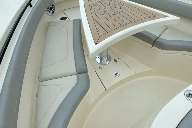  Yacht Photos Pics 2020 Scout 355 LXF boat interior with cushioned seating and a stylish wooden table.