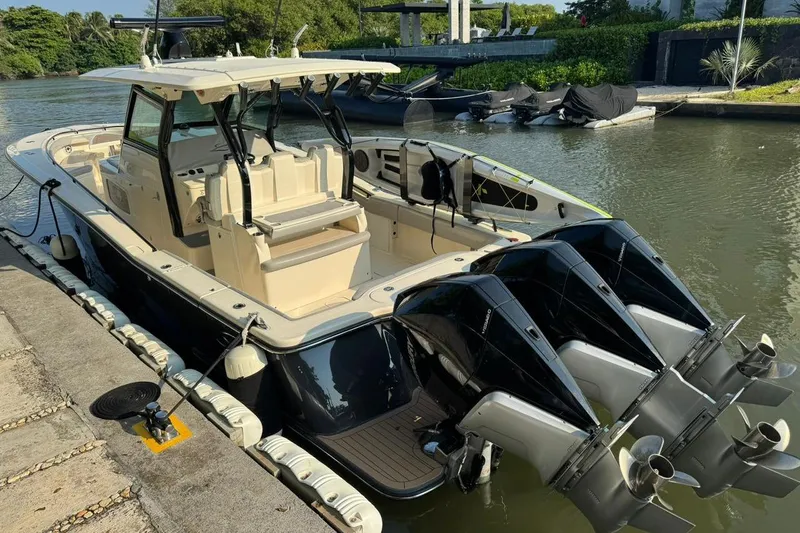  Yacht Photos Pics 2020 Scout 355 LXF boat docked with triple outboard engines.