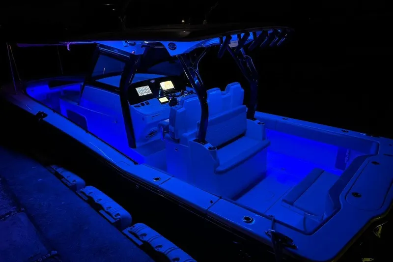  Yacht Photos Pics 2020 Scout 355 LXF boat illuminated with blue LED lights at night.
