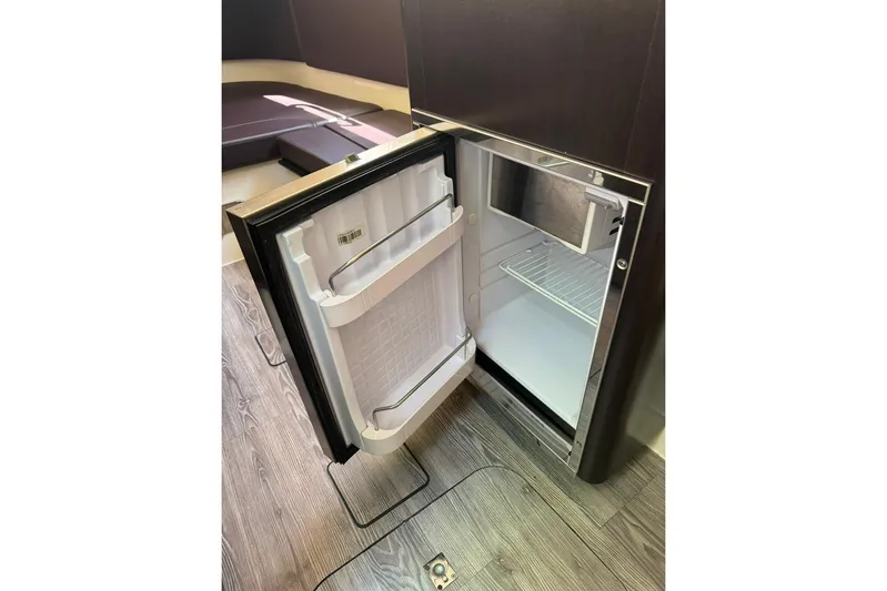  Yacht Photos Pics Open refrigerator inside 2020 Scout 355 LXF boat, showcasing interior storage space.