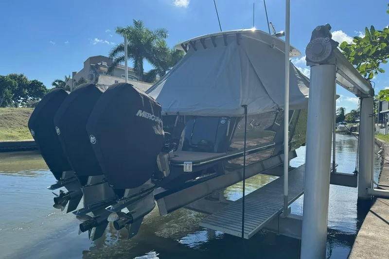  Yacht Photos Pics 2020 Scout 355 LXF boat with triple Mercury engines on a lift.