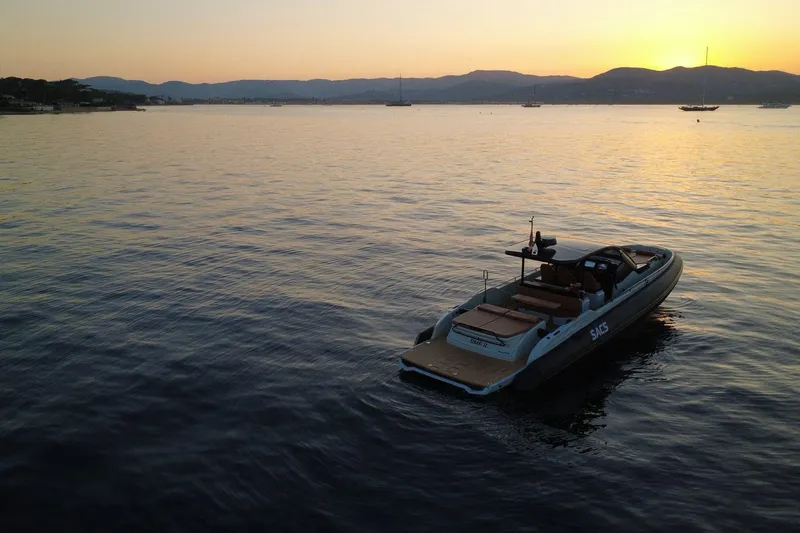 Rmf Yacht Photos Pics 2022 SACS Rebel 47 yacht at sunset on calm waters.