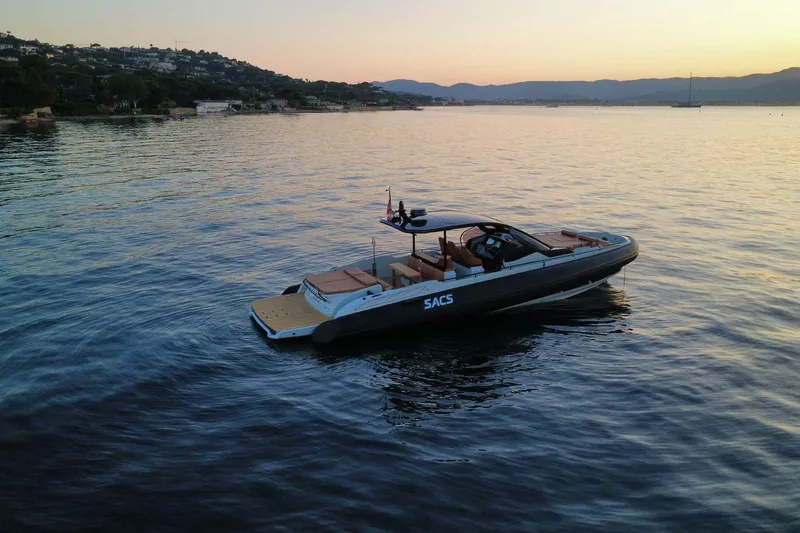 Rmf Yacht Photos Pics 2022 SACS Rebel 47 yacht at sunset on calm waters.