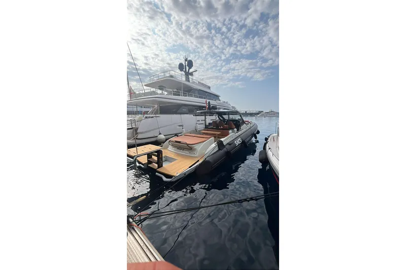 Rmf Yacht Photos Pics 2022 SACS Rebel 47 yacht docked in marina under partly cloudy sky.