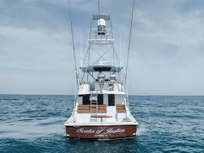 Scales Of Justice Yacht Photos Pics 1999 Hatteras 60 Convertible yacht on open sea, rear view.