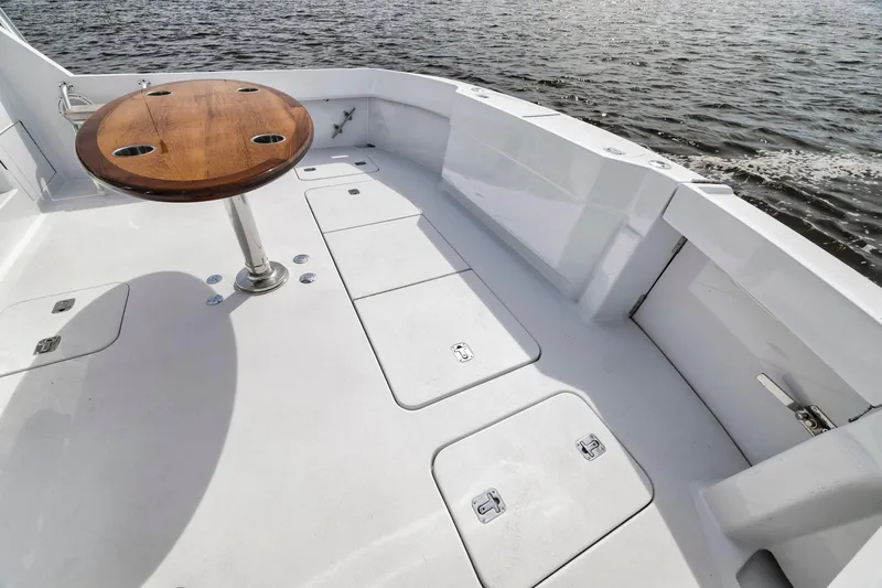 Scales Of Justice Yacht Photos Pics 1999 Hatteras 60 Convertible yacht deck with wooden table, overlooking calm waters.