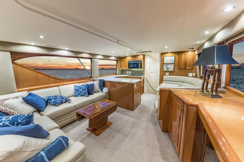 Scales Of Justice Yacht Photos Pics Luxurious interior of 1999 Hatteras 60 Convertible yacht with elegant furnishings and ocean view.